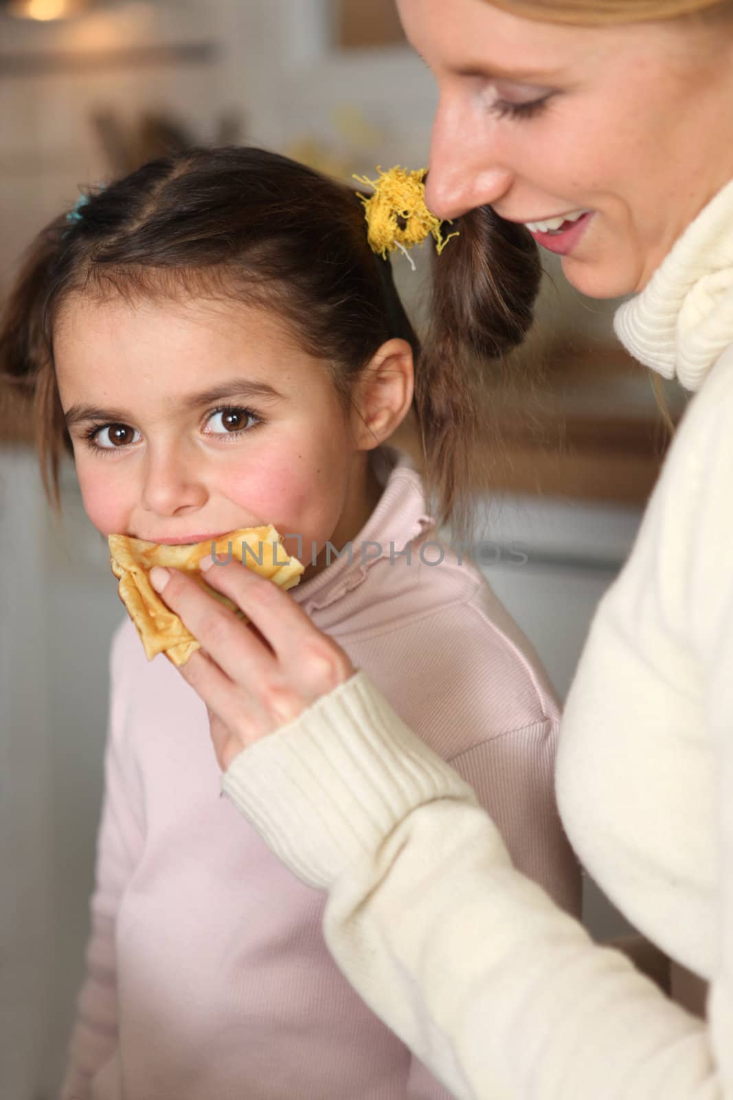 Mother giving her daughter a snack