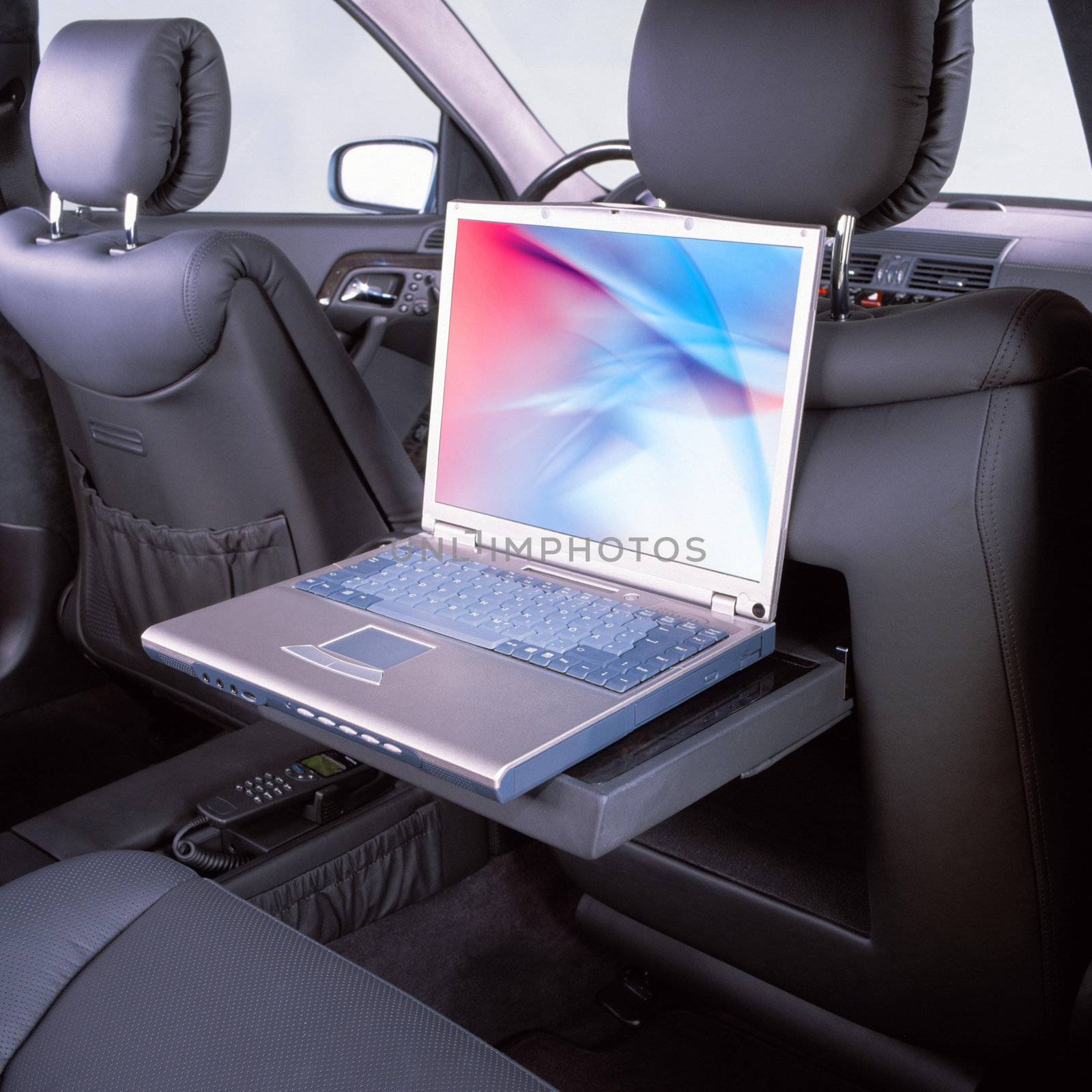 laptop in the passenger compartment of premium car