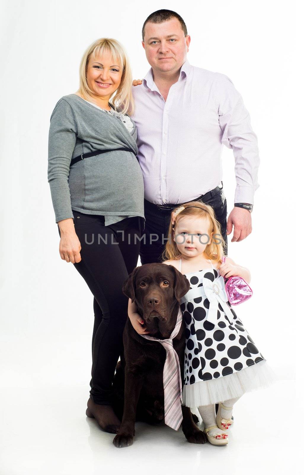 Happy family with black dog in studio over white