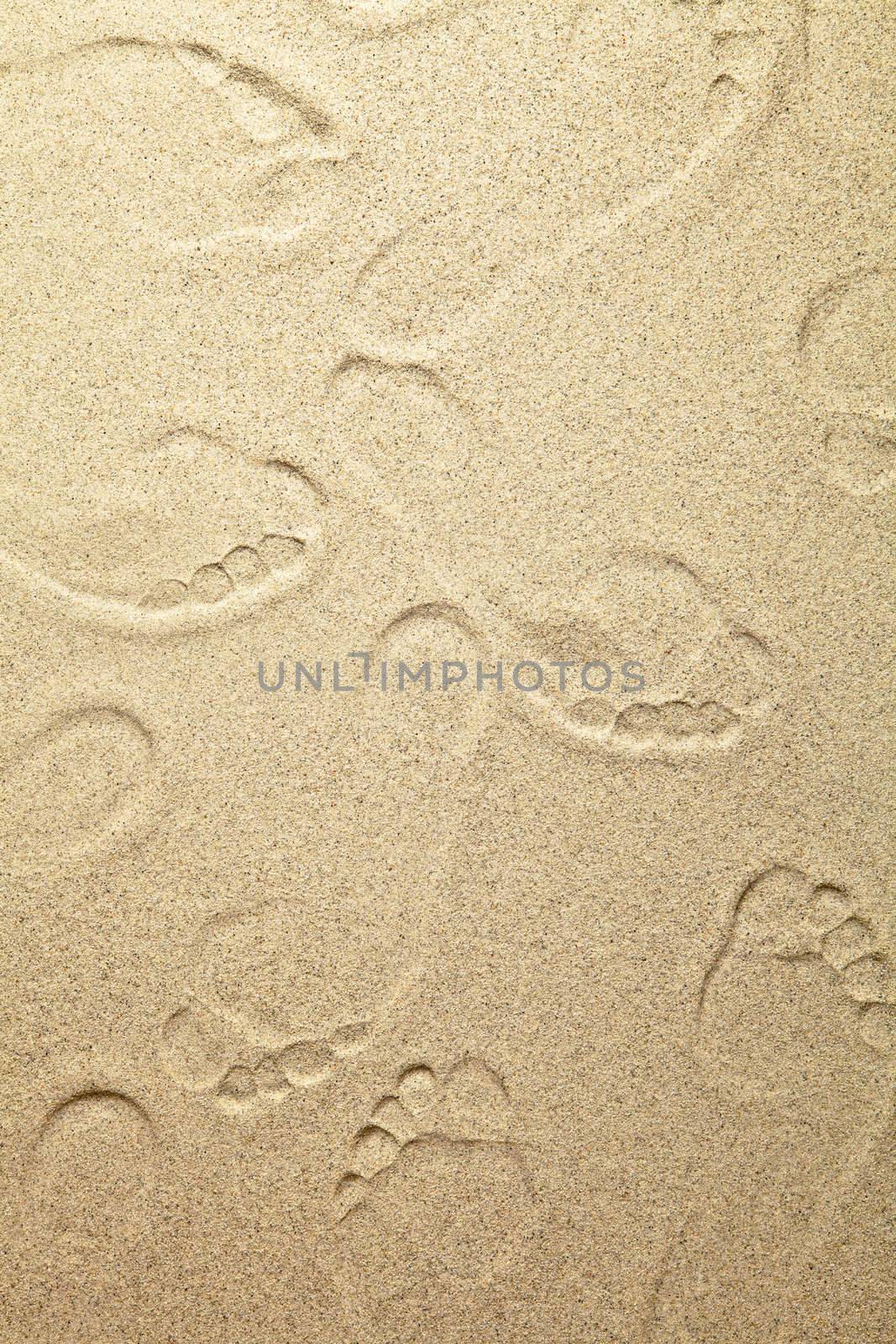 Sandy beach background with footprints for summer