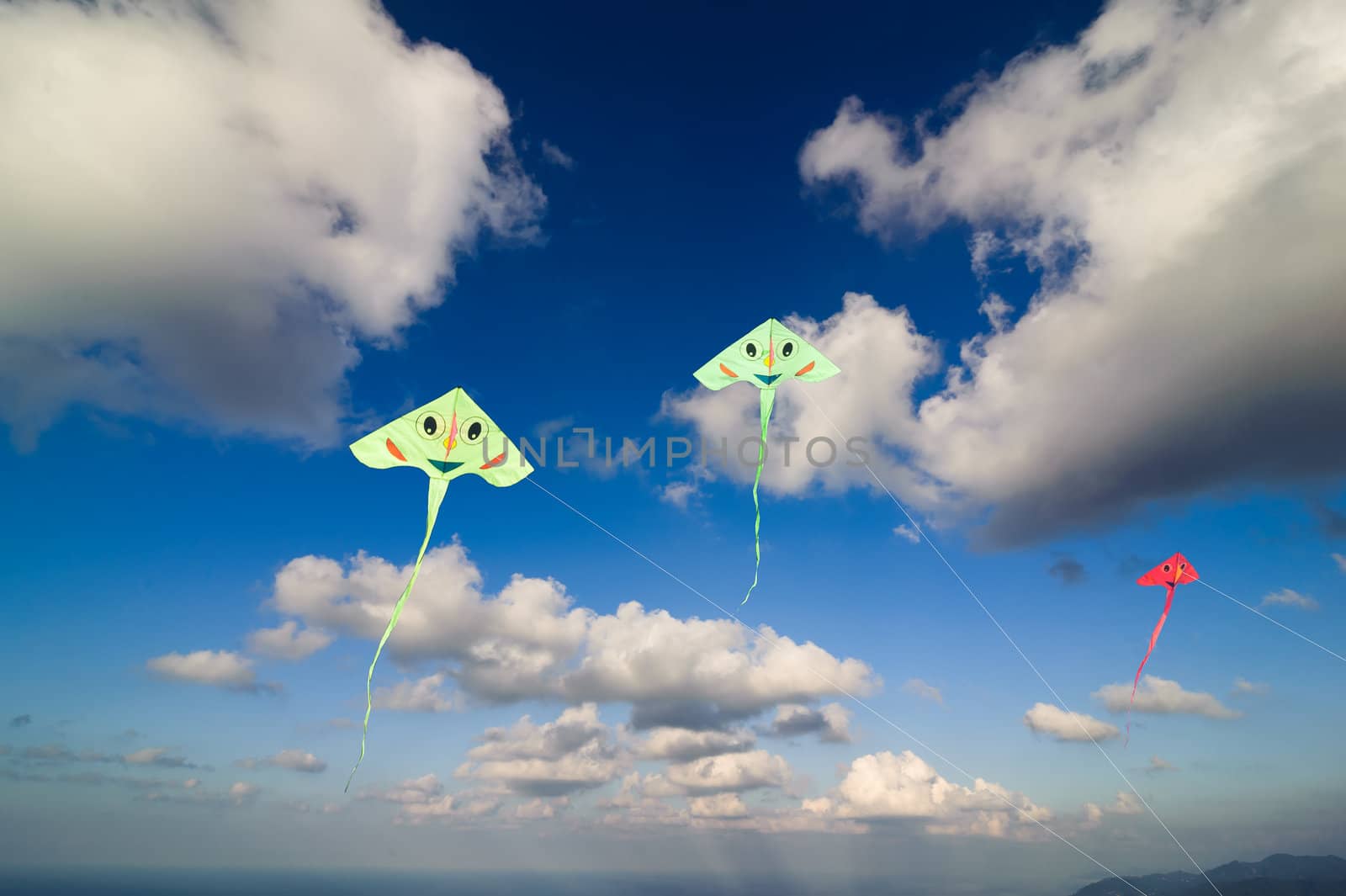 Flying colorful kites in blue sky by oguzdkn