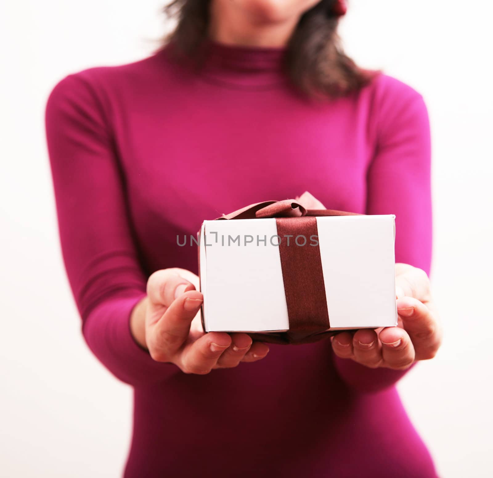 Silhouette of a woman holding a present