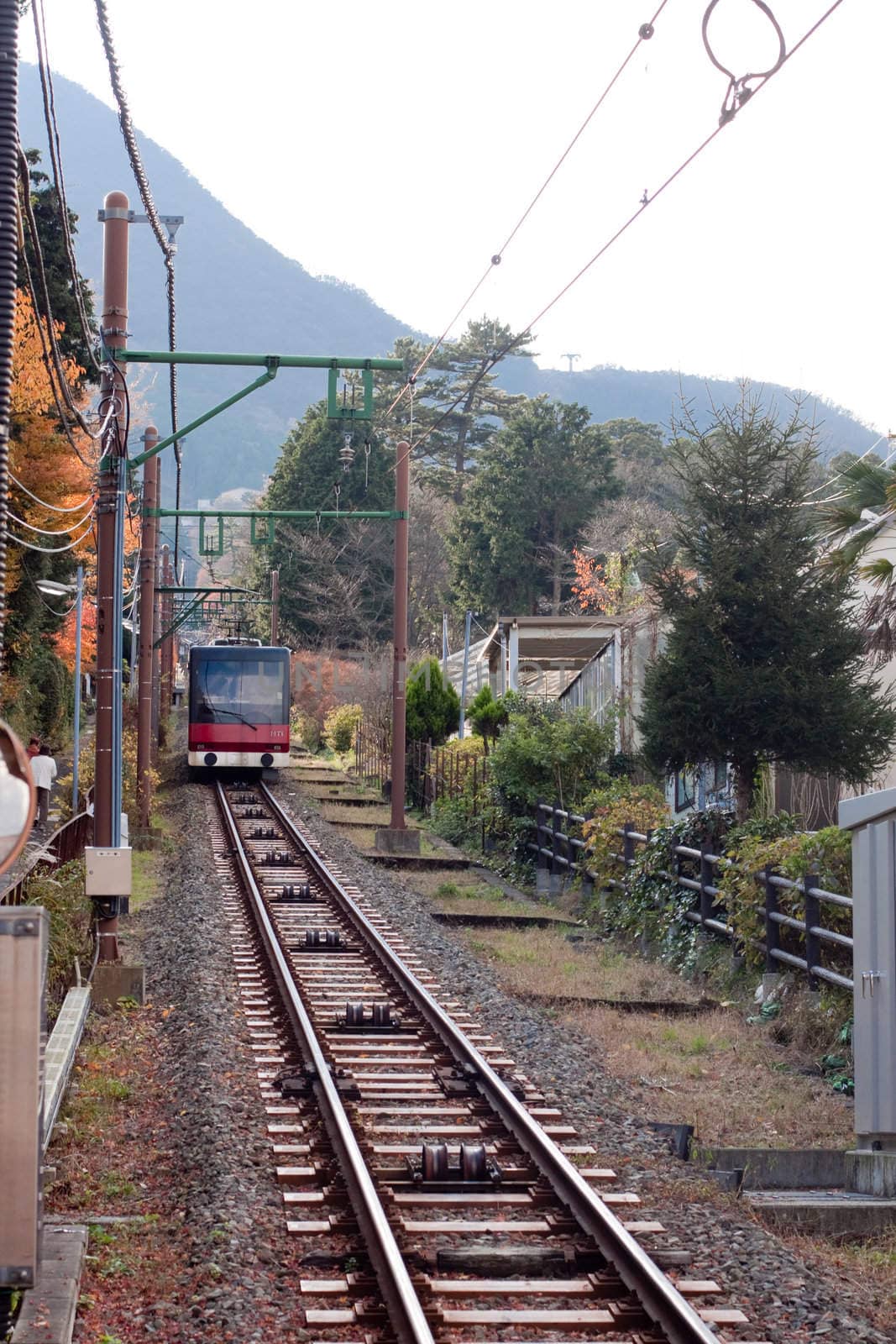 A railway in japanese mouintains with red train
