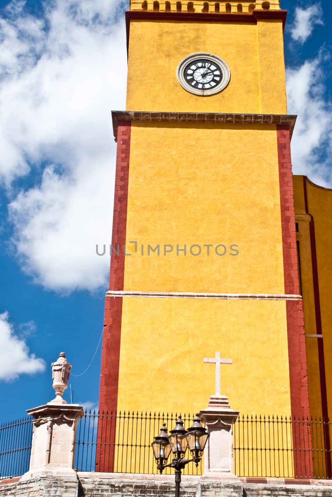Vibrant yellow clock tower in Guanajuato, Mexico