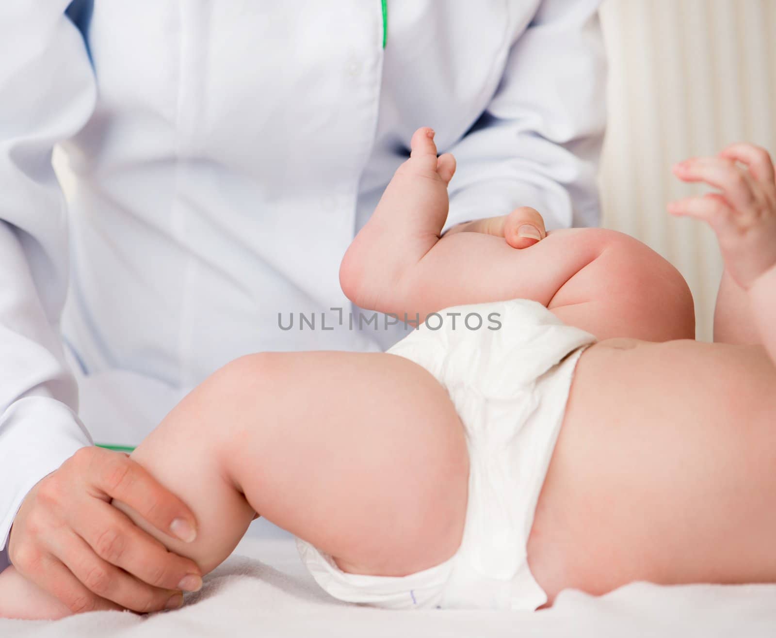 woman massaging little baby girl