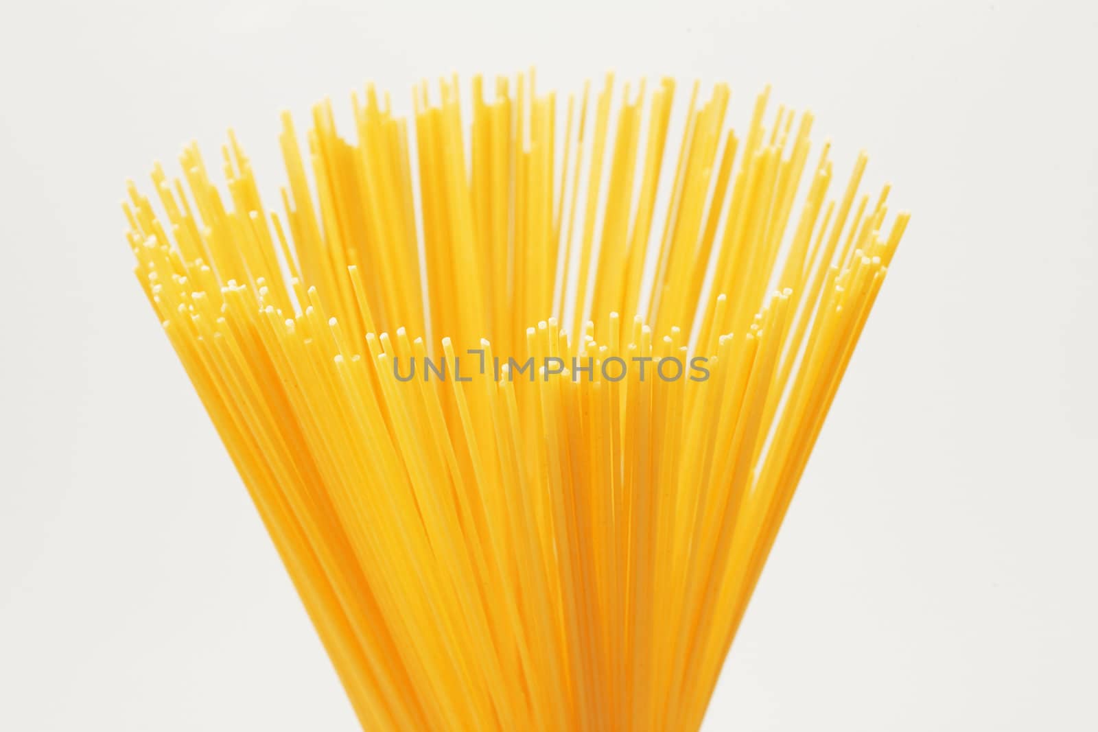 Bunch brightly yellow a spaghetti on a white background