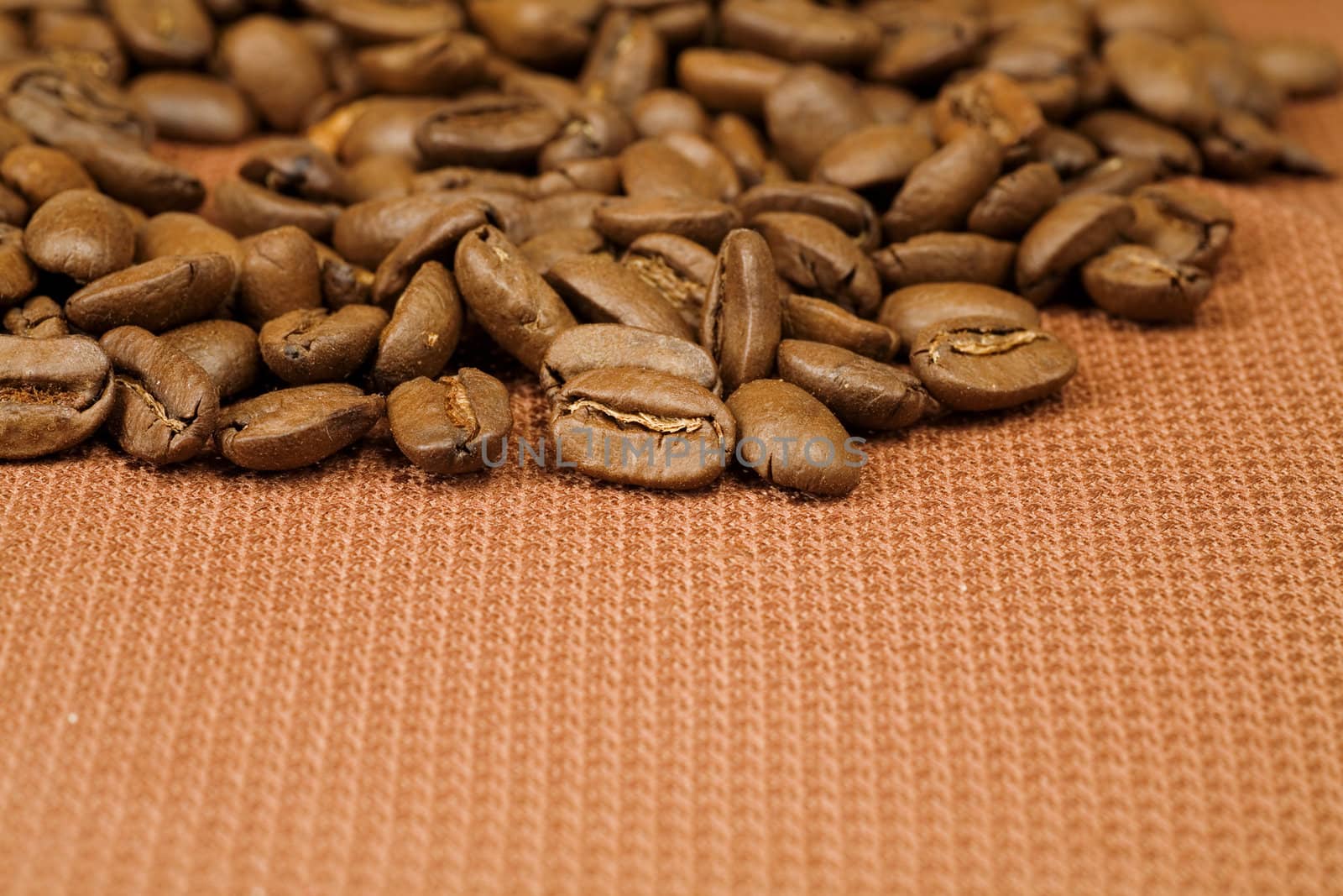 scented coffee beans scattered on a brown braided material