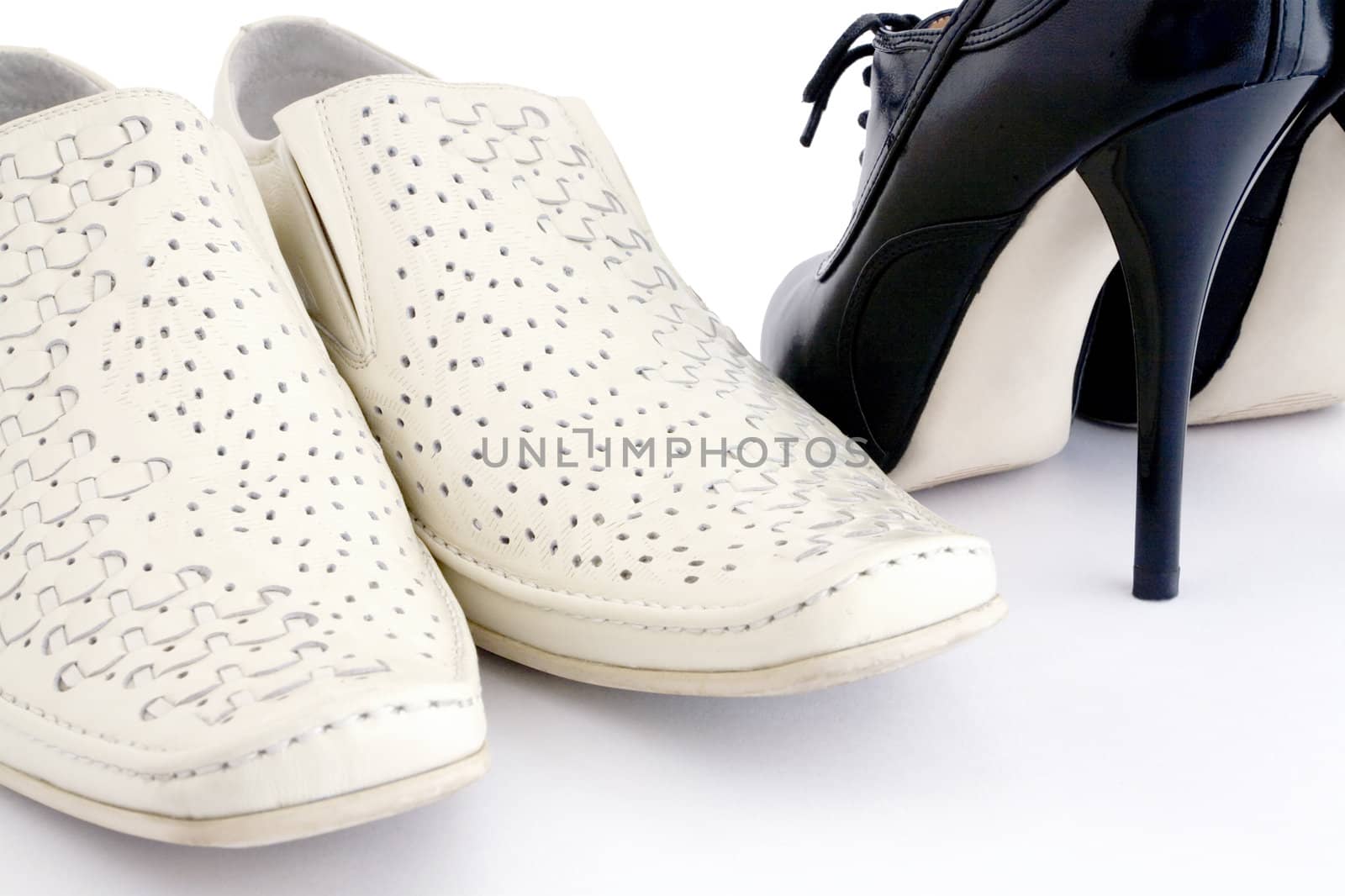 Man's and woman's leather shoes on a white background