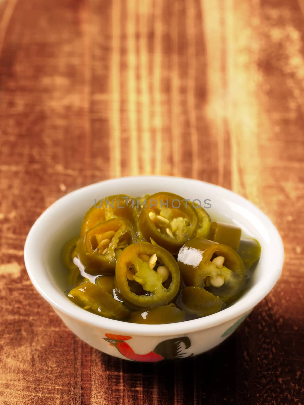 close up of a bowl of asian pickled green chilies