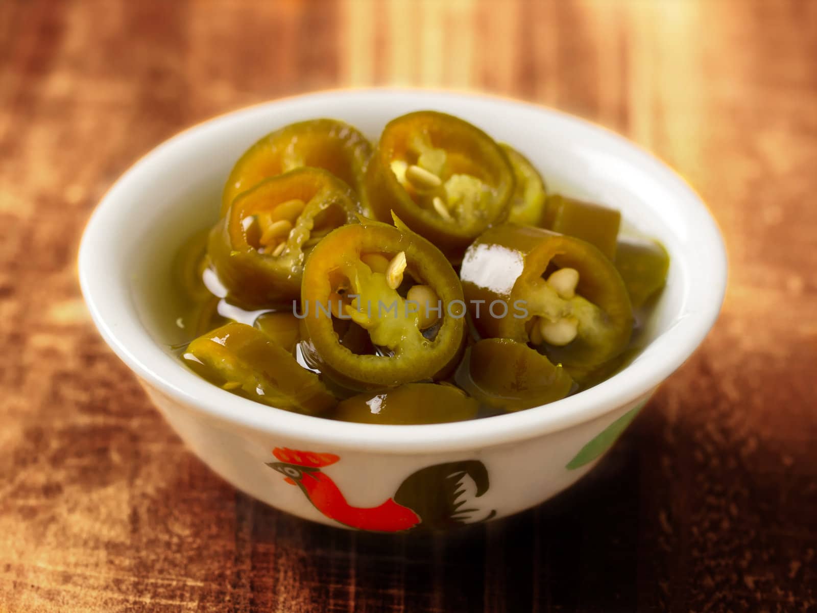 close up of a bowl of asian pickled green chilies