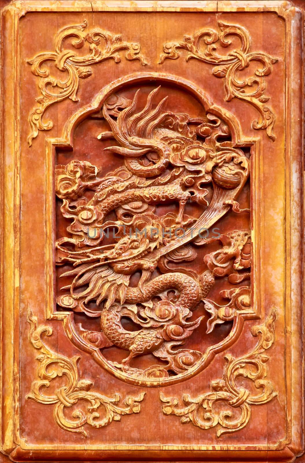 Dragon design on the wooden door of Chinese temple