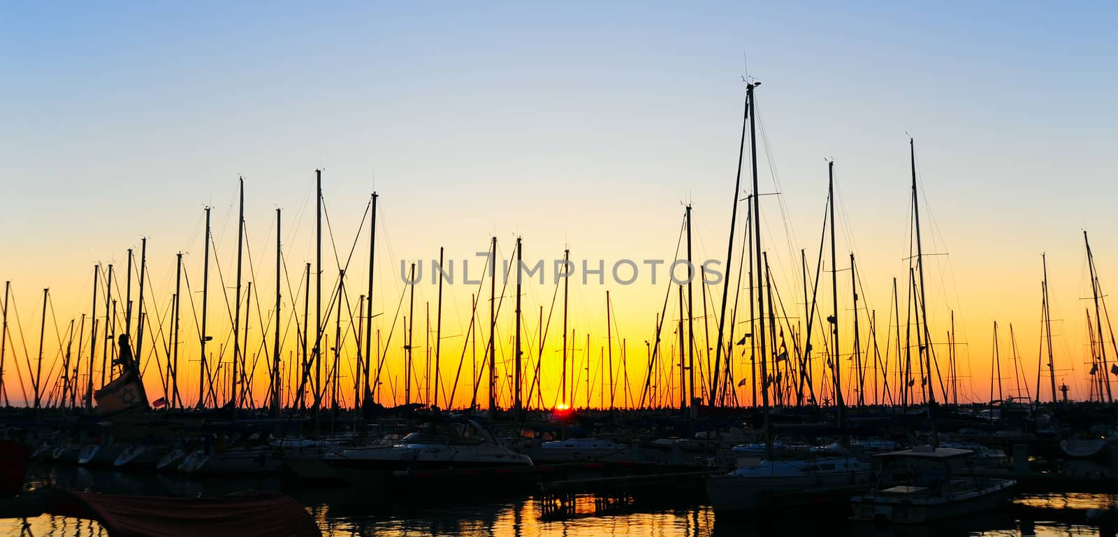 Marina With Docked Yachts At The End Of The Day.