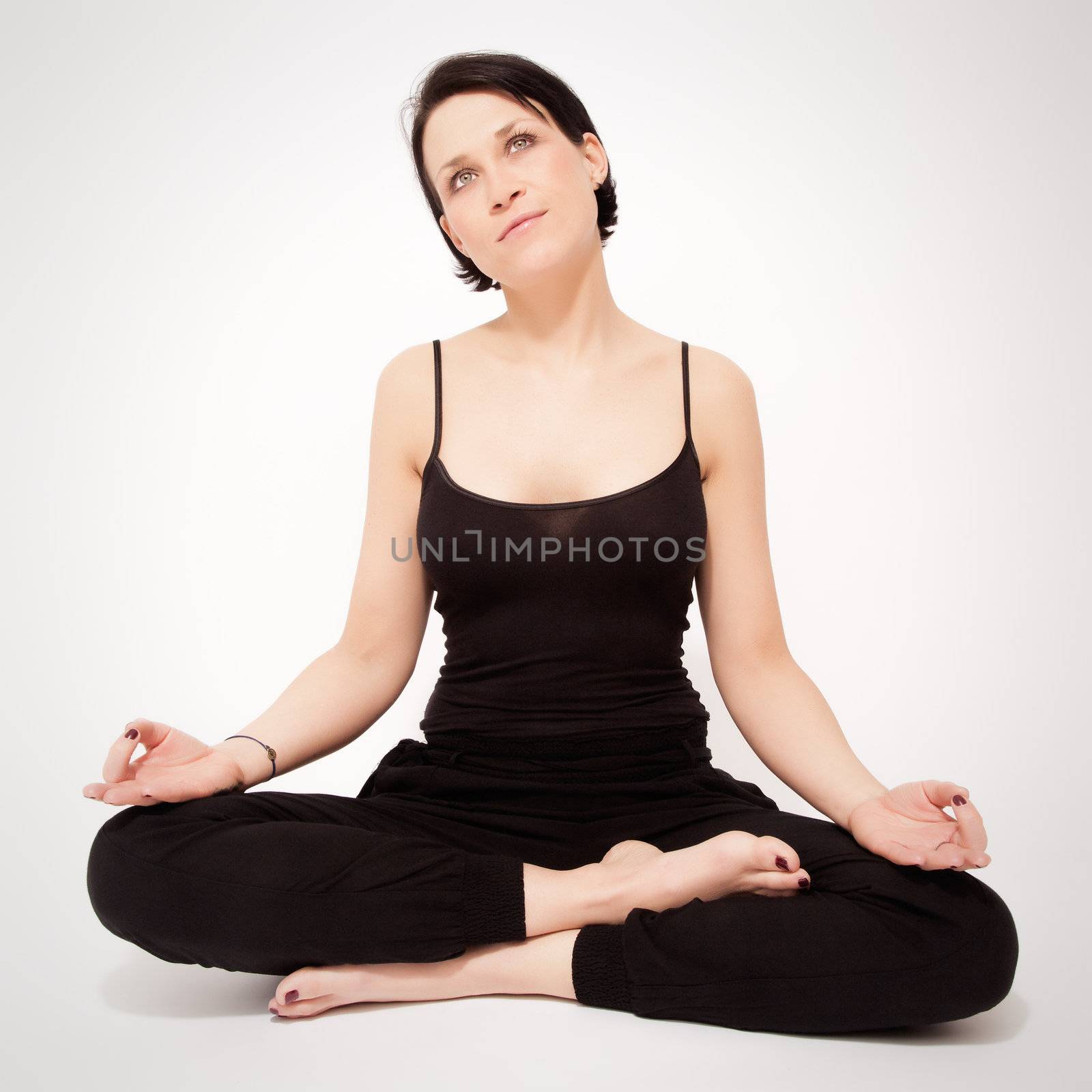 An image of a pretty woman doing yoga at home