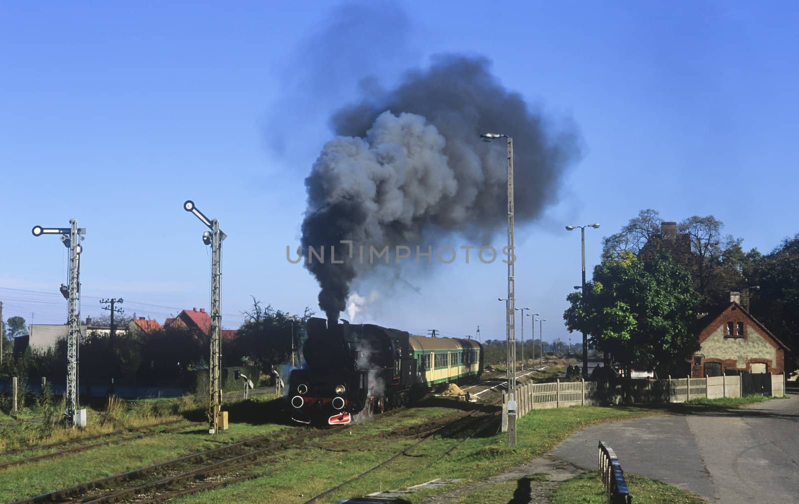 Old retro steam train stopped at the small station
