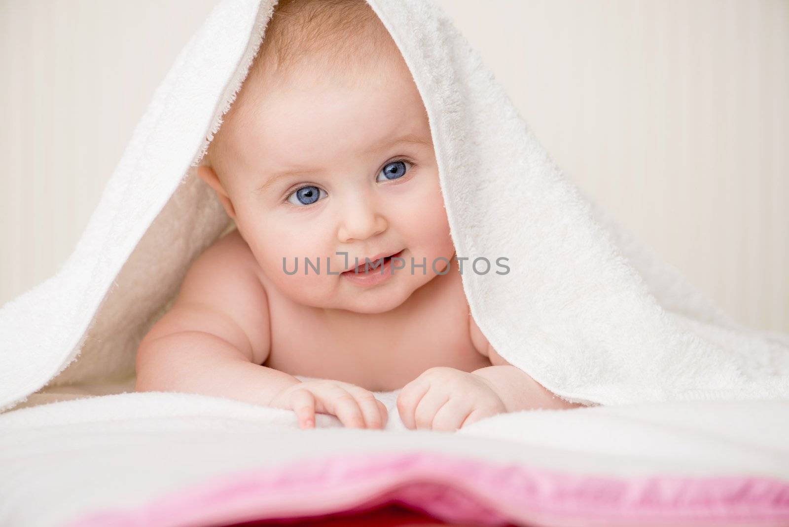 smiling beautiful baby with a towel