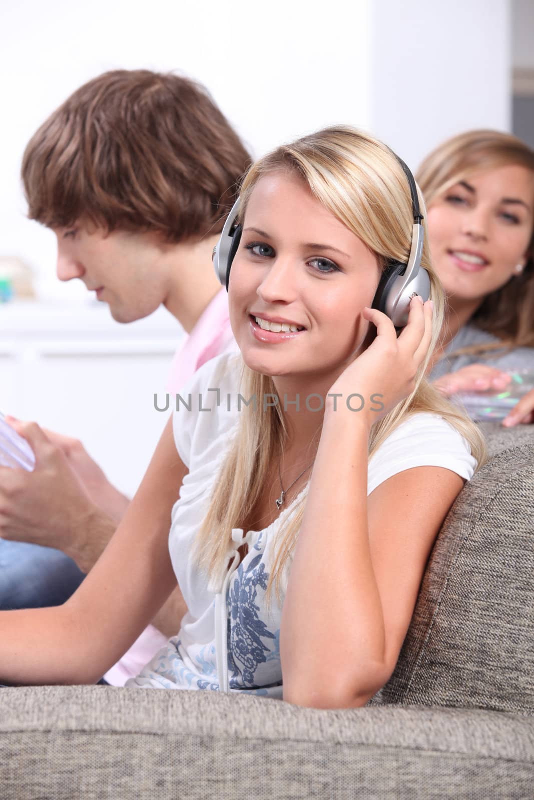 Blond teenagers wearing headphones