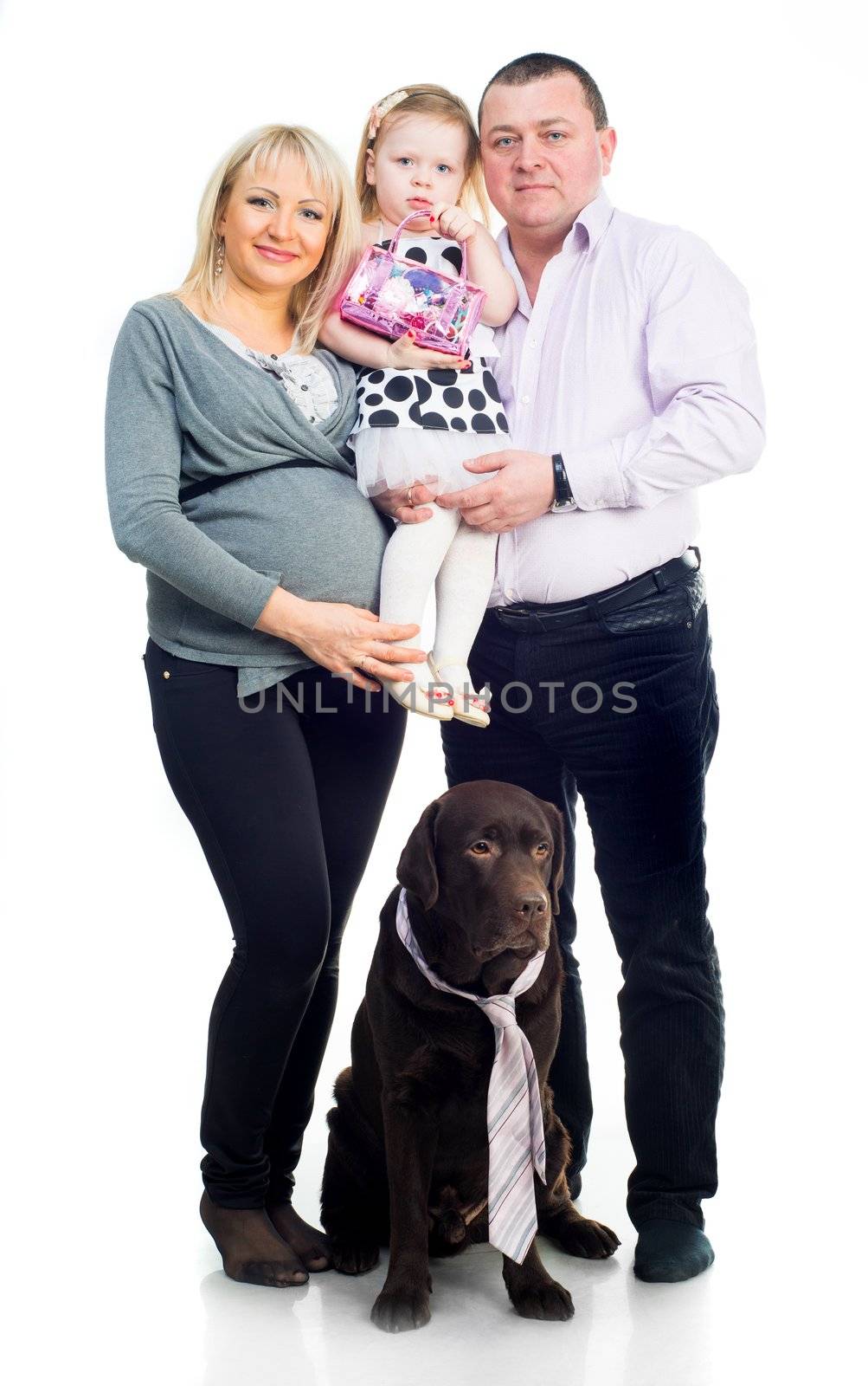 Family with black retriver in studio on a white