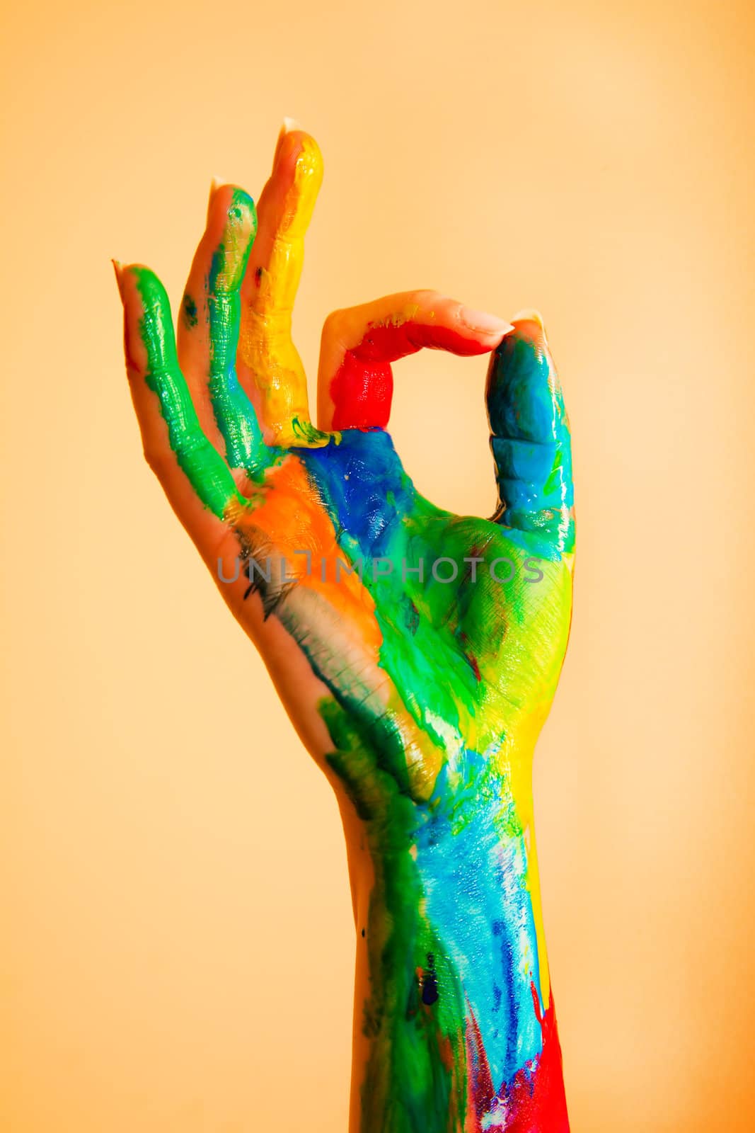 Painted hand with OK sign, colorful fun. by photocreo