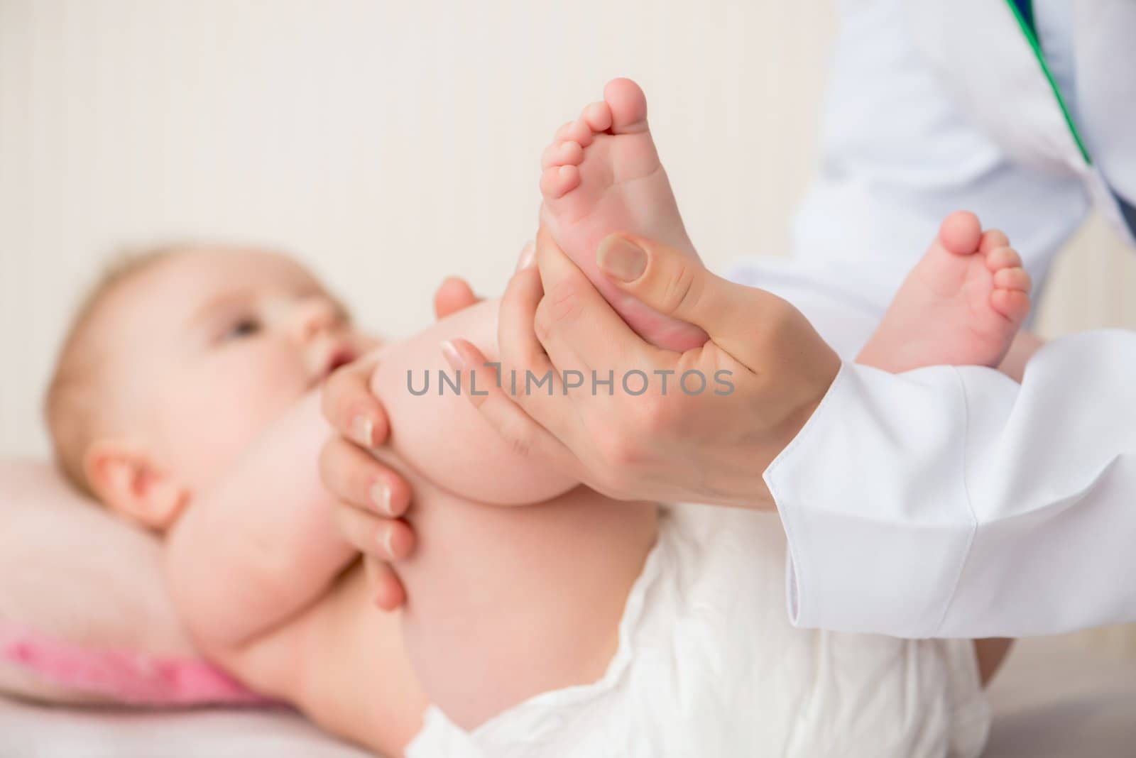 Doctor massaging  baby by GekaSkr