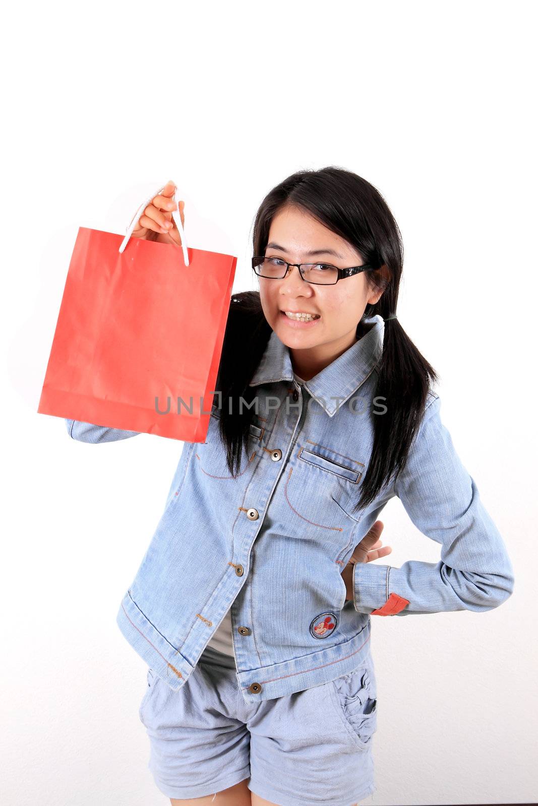 Happy shopping woman show her bags and smiling isolated over whi by rufous