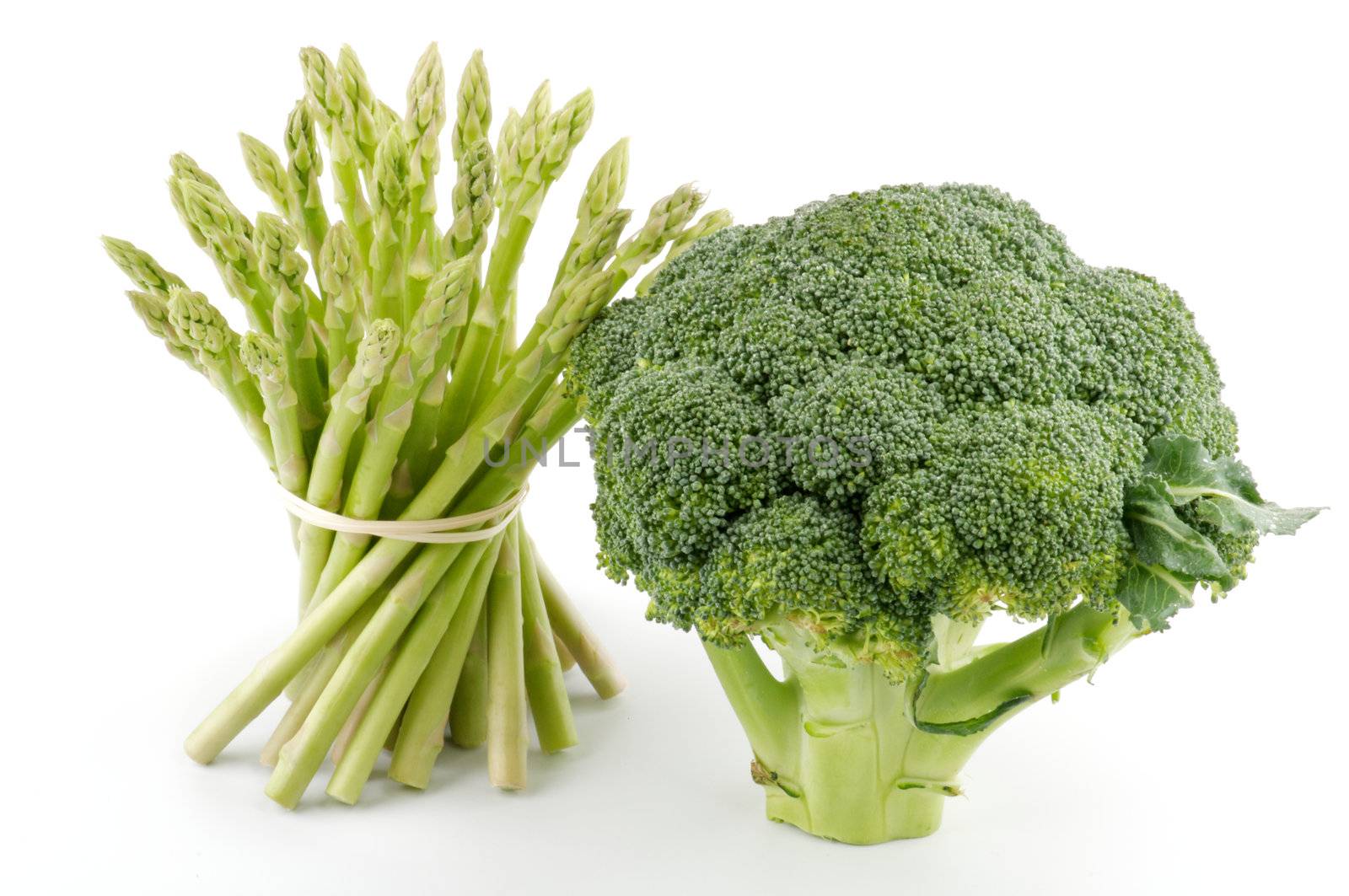 Asparagus sprouts and broccoli floret isolated on white background