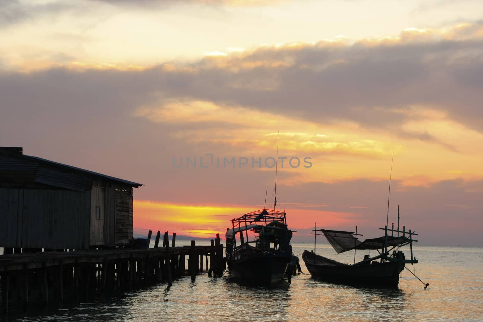 Silhouette of traditional fishing boats at sunrise, Koh Rong isl by donya_nedomam