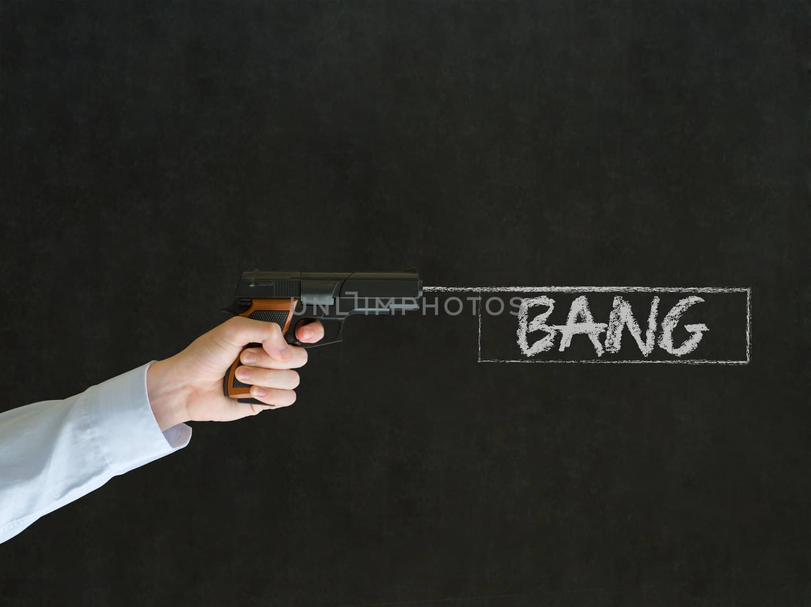 Business man, student or teacher pointing a gun with bang text on blackboard background