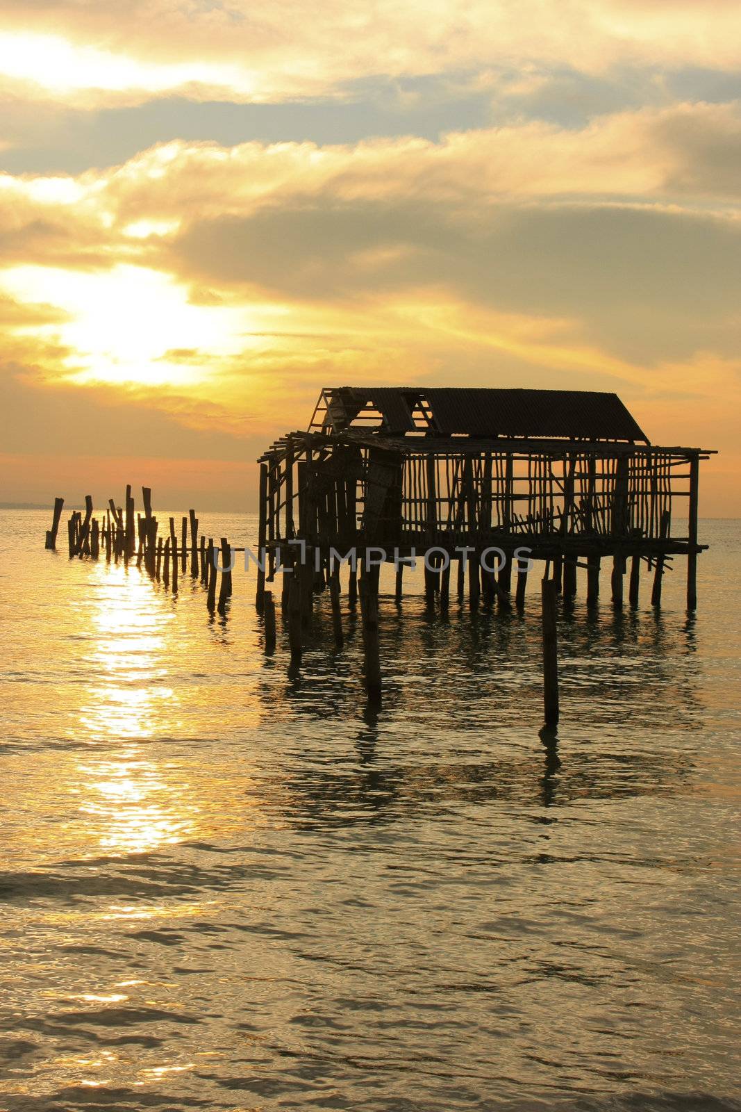 Silhouette of old wooden jetty at sunrise, Koh Rong island, Cambodia, Southeast Asia