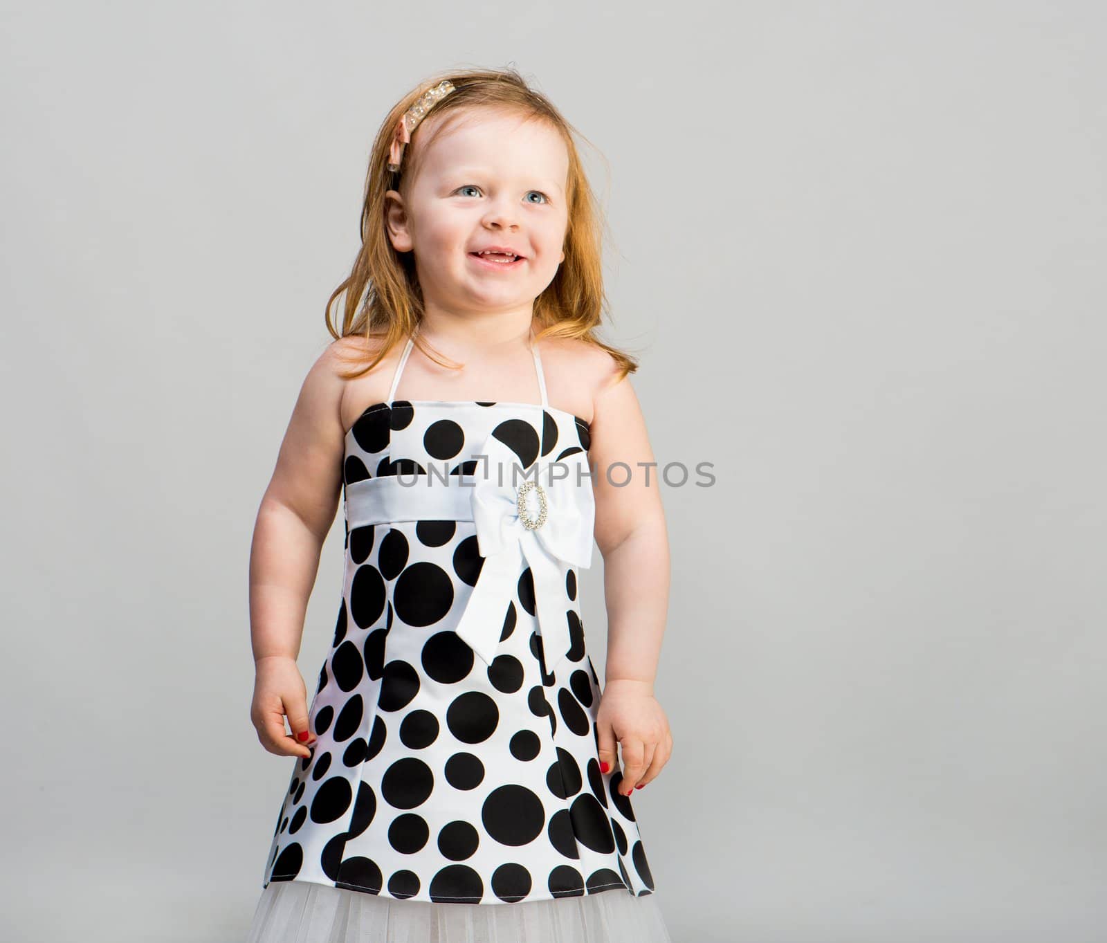 little girl in studio in gray background