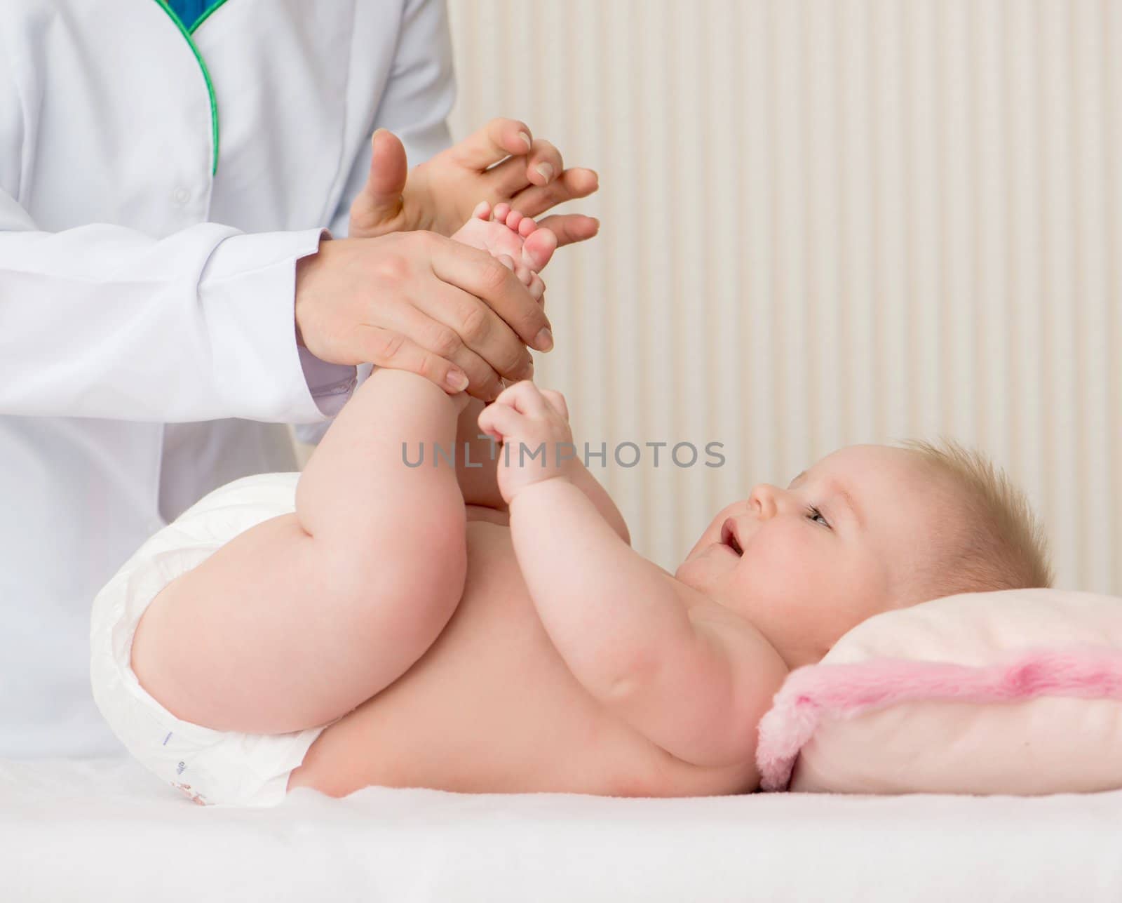 Mother's hands massaging little baby