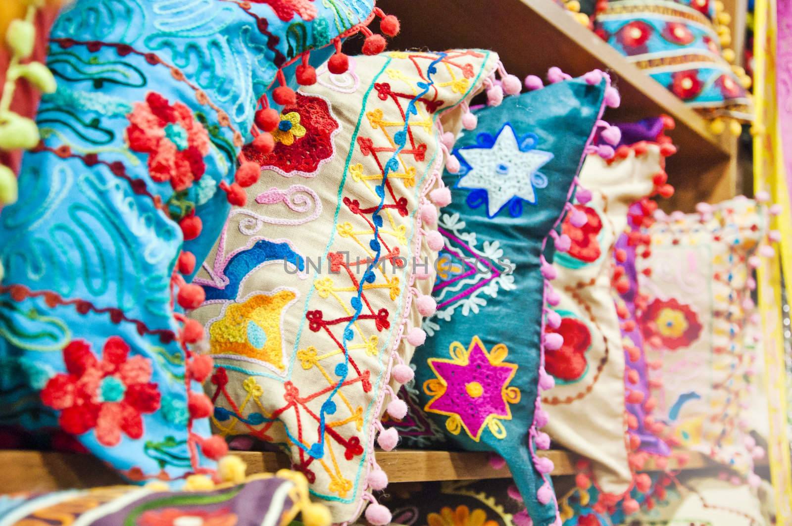 Pillows with traditional Turkish designs on the shelves of a bazaar store in Istanbul