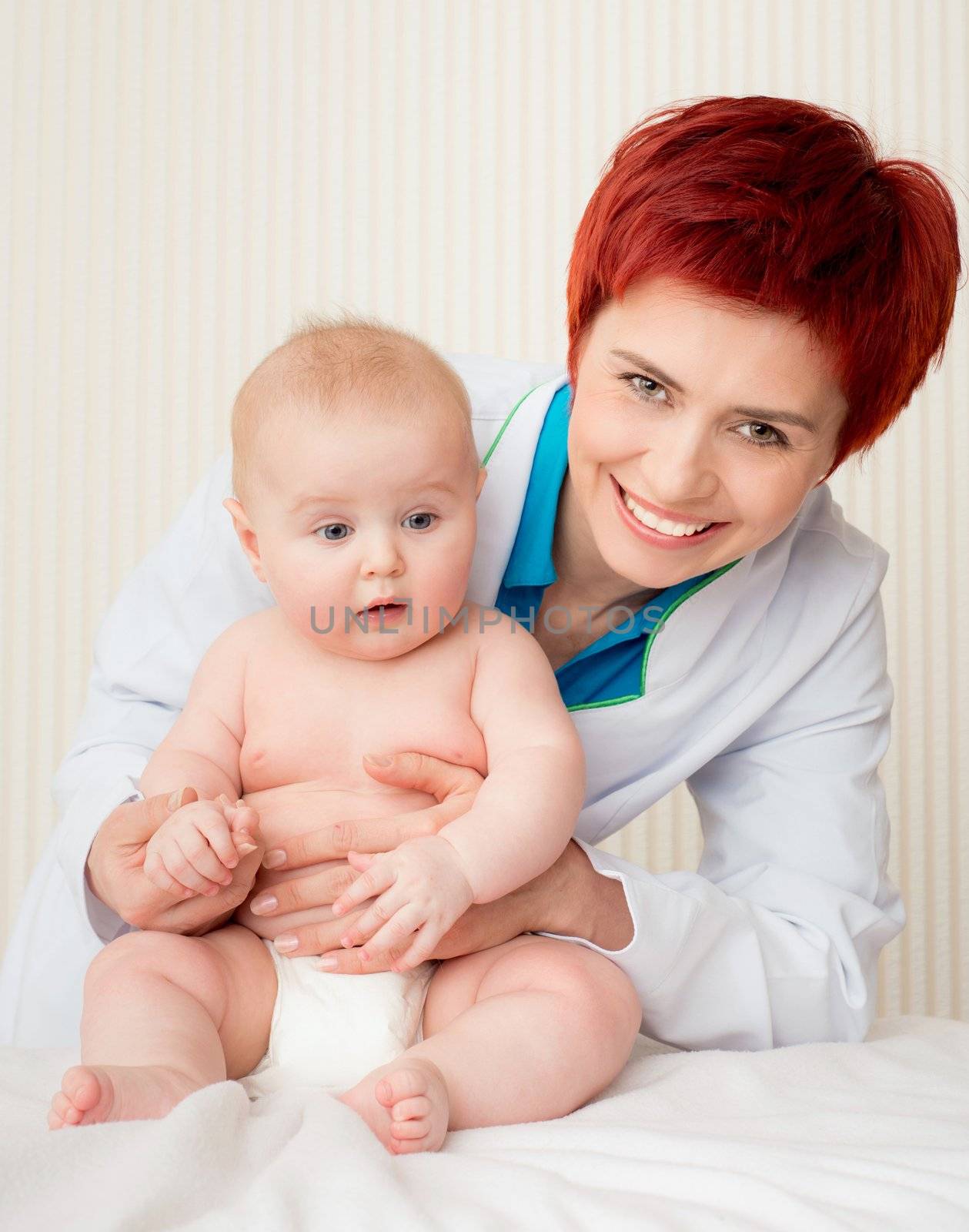 Smiling doctor with adorable baby