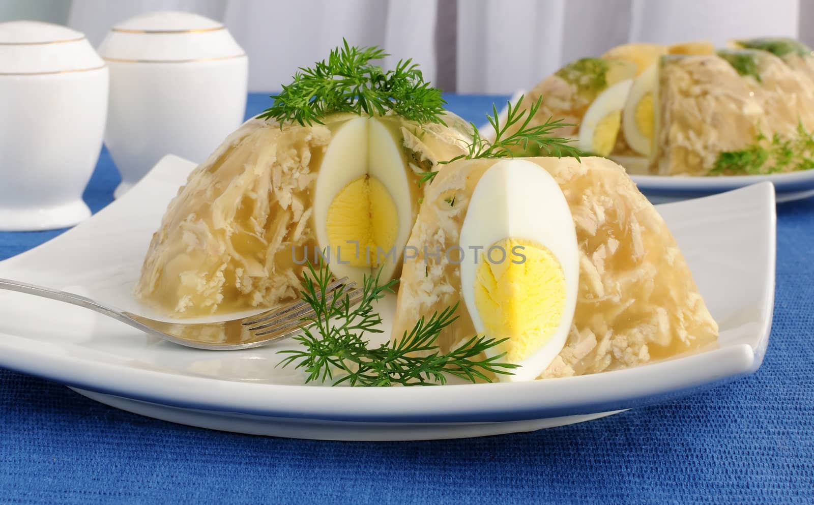 Jellied chicken decorated with egg and dill