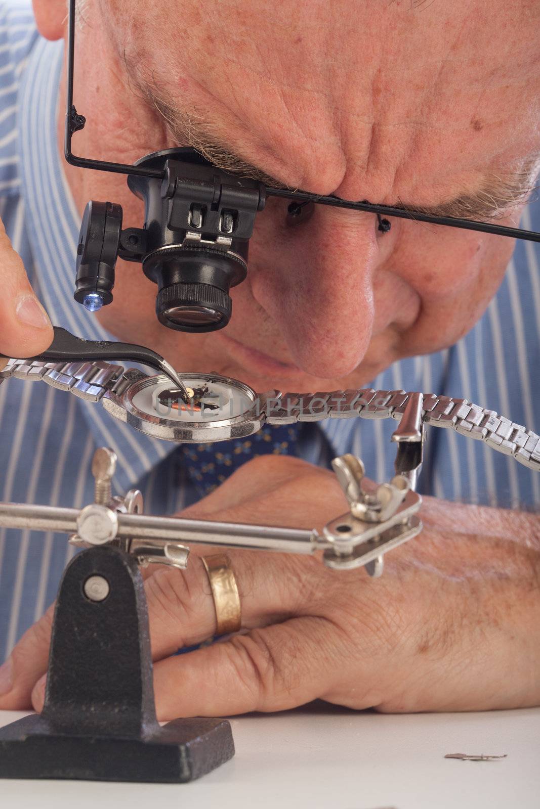 Close-Up of Man Repairing Wrist Watch by Daniel_Wiedemann