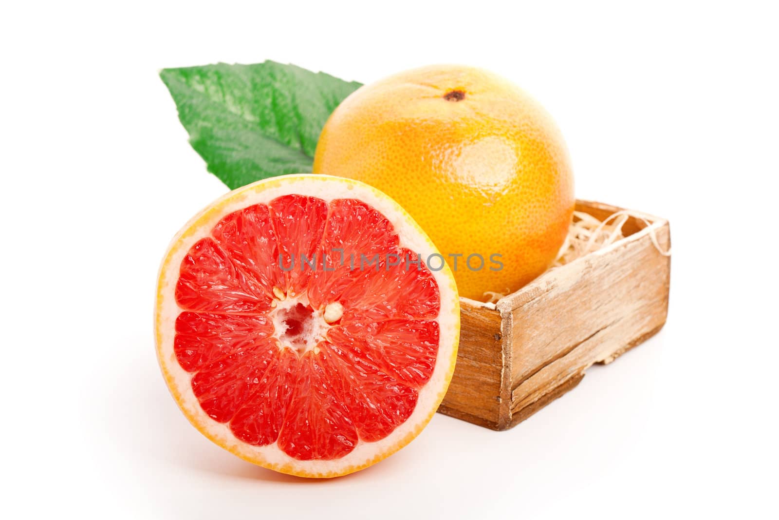grapefruit  in the wooden bowl. on white background  by motorolka