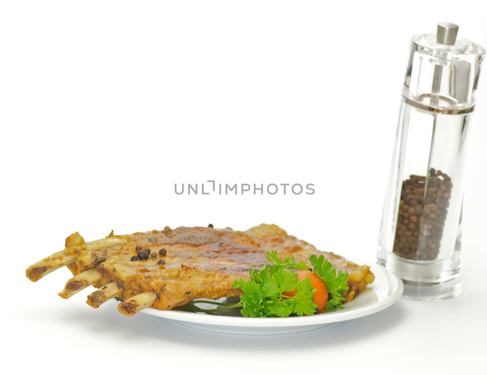 Barbecued pork ribs on white plate isolated on white background