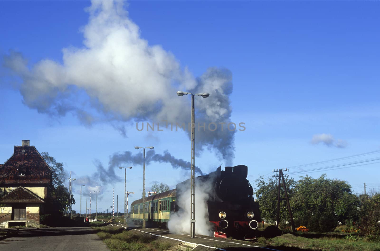 Old retro steam train stopped at the small station
