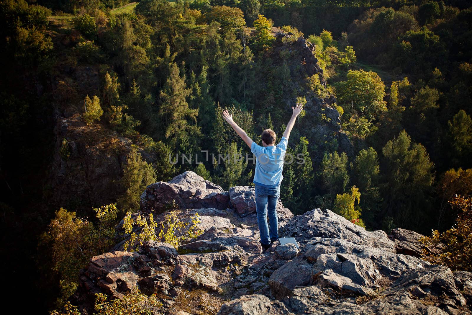 young man standing on a rock slope by jannyjus
