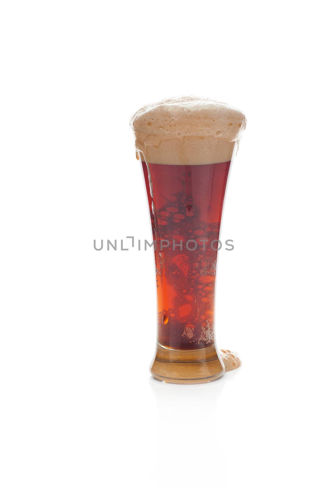 dark beer with the foam in a tall glass isolated on white