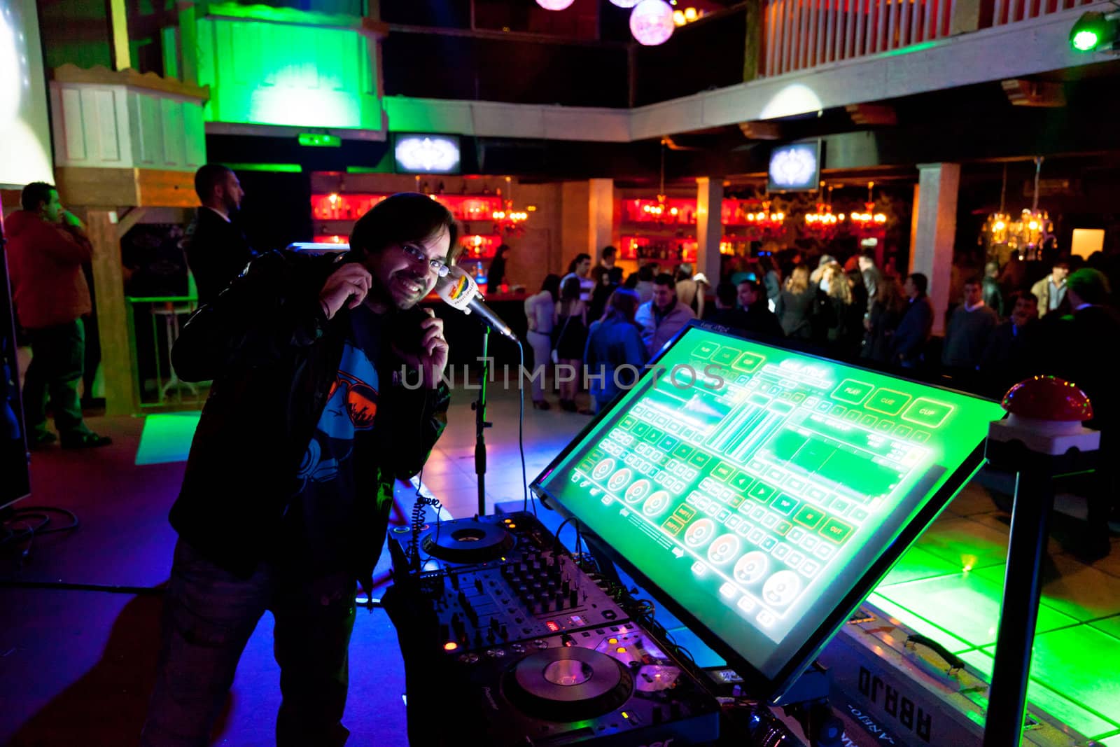 CHICLANA, SPAIN - JAN 27: DJ Alvaro Reina next to the mixer to begin the party of the hot mix energy danceflor of the Los 40 Principales  on Jan 27, 2012 in Chiclana, Spain