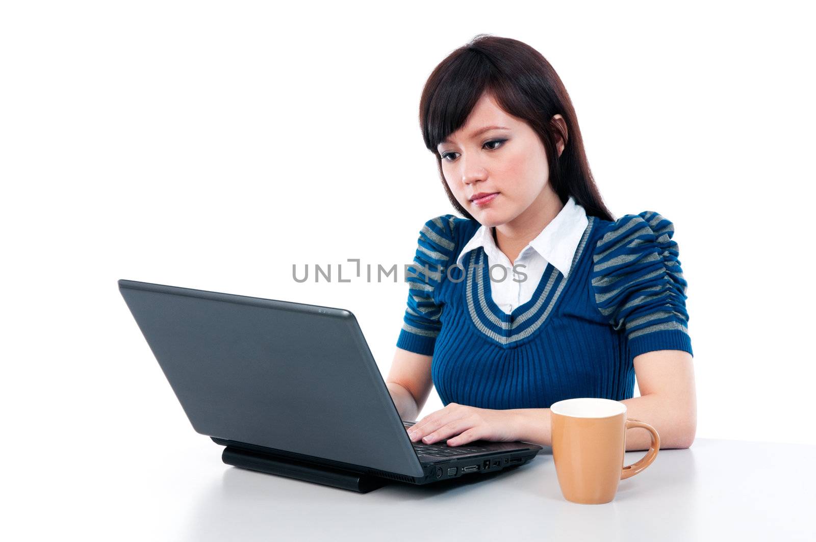 Portrait of an attractive Asian girl using laptop over white background.