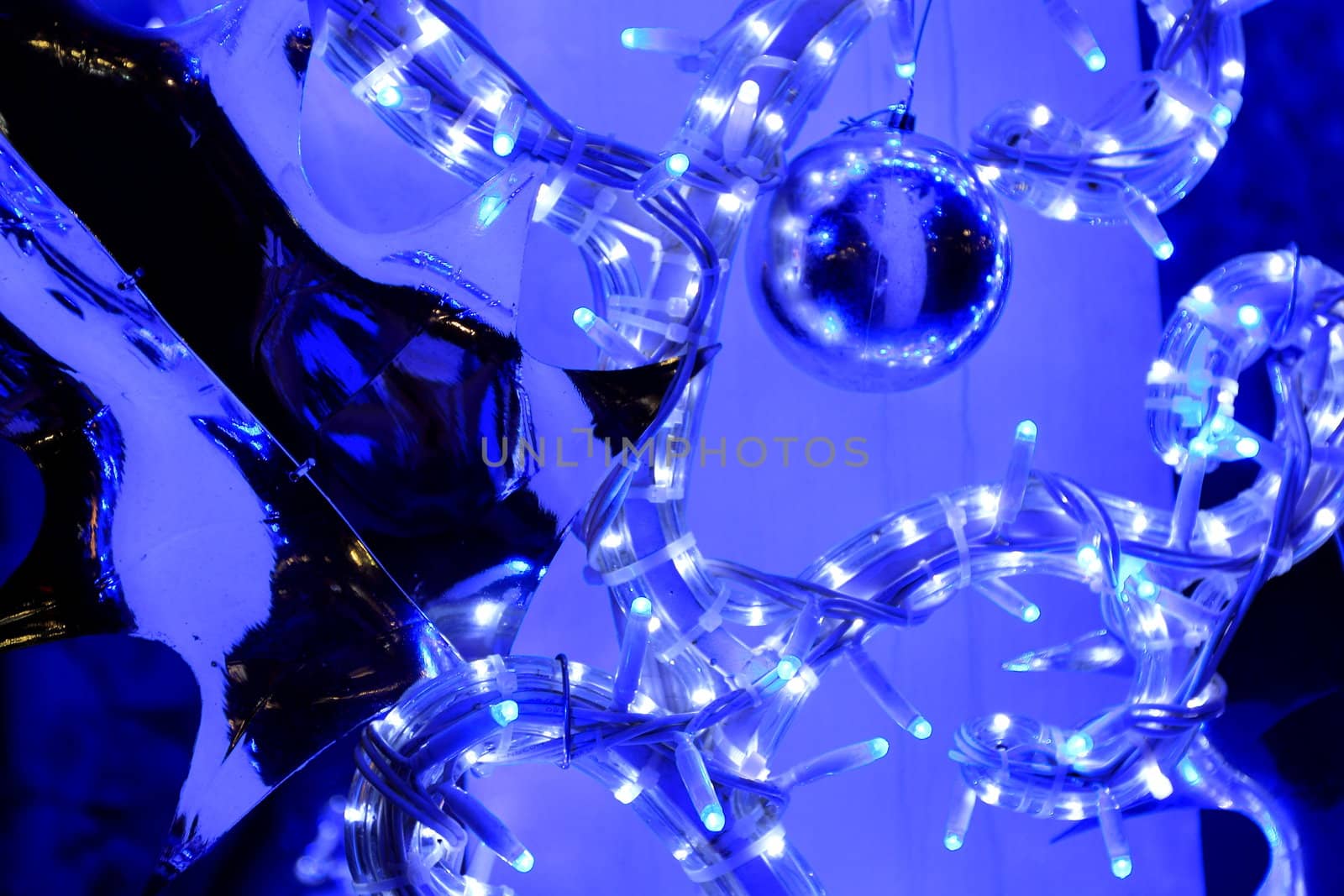 Abstract blue background with blue fairy lights and metallic foil