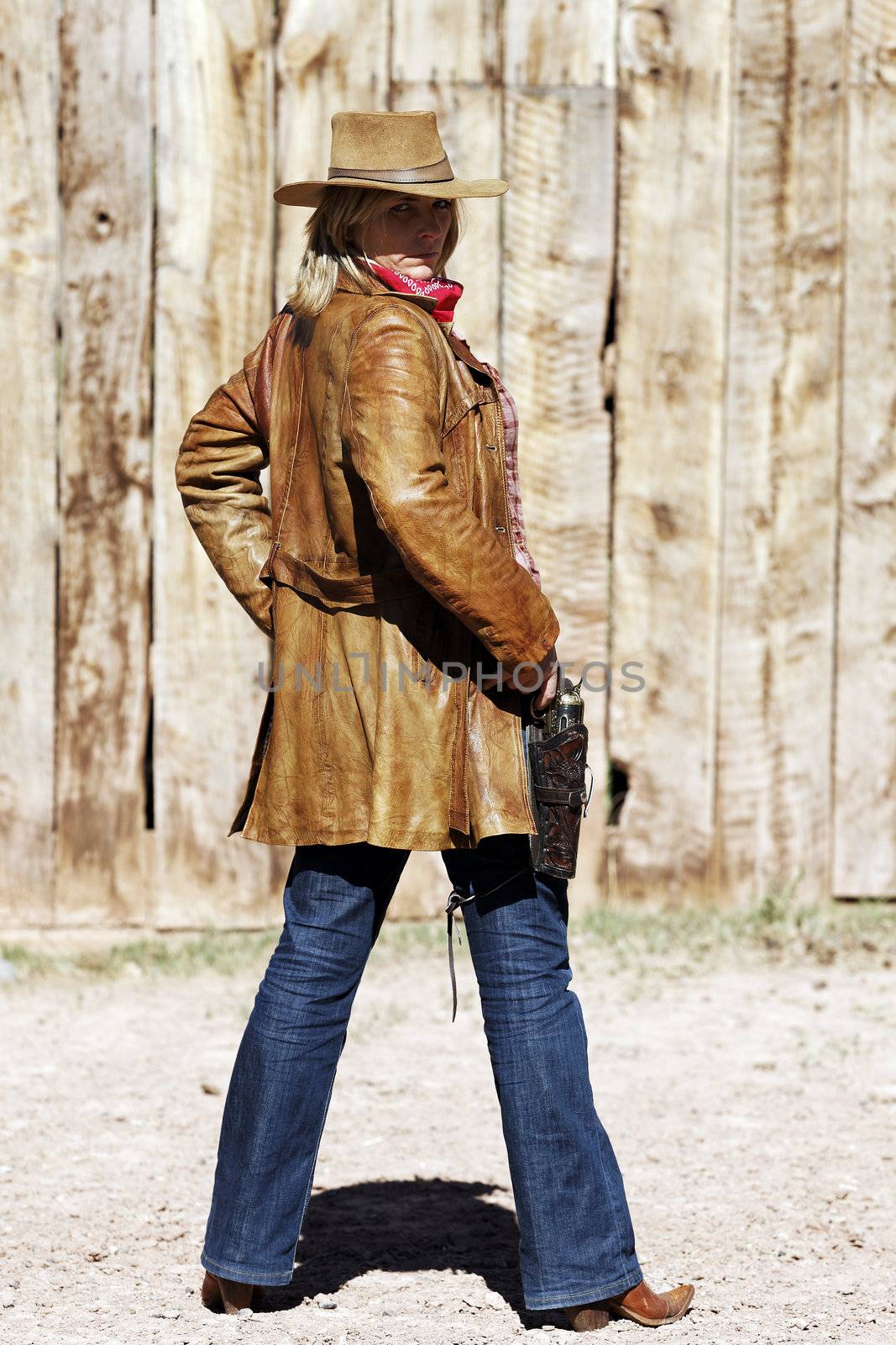 Portrait of a blond cowgirl. Western movie style 