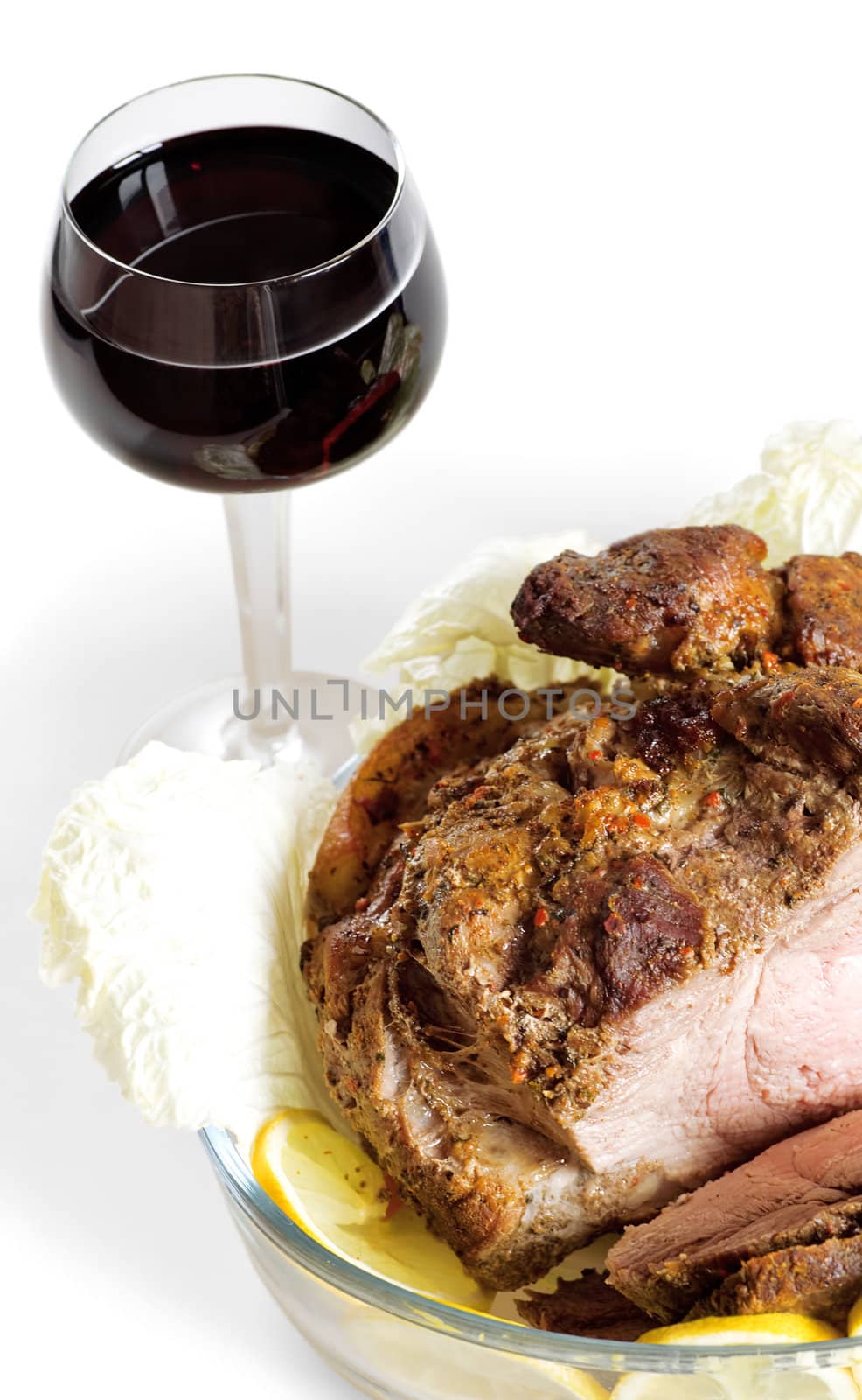 Red wine in a glass and fried meat on a white background