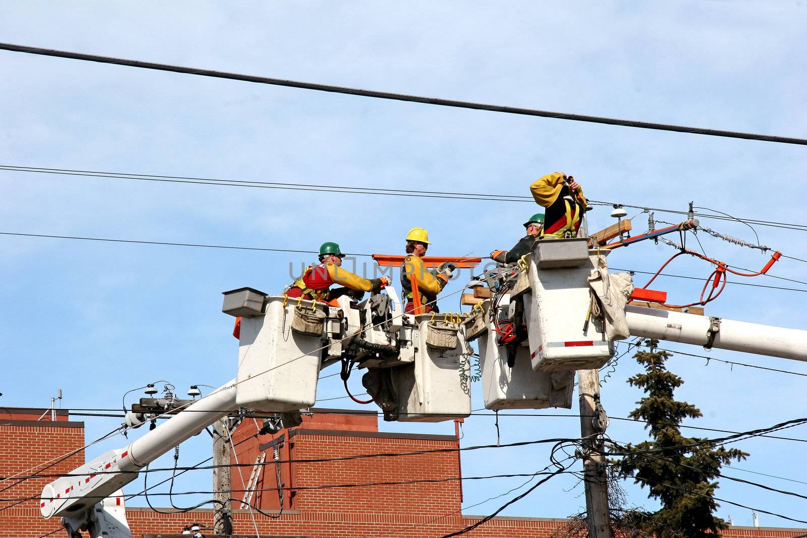 City workers repairing electrical overhead wiring