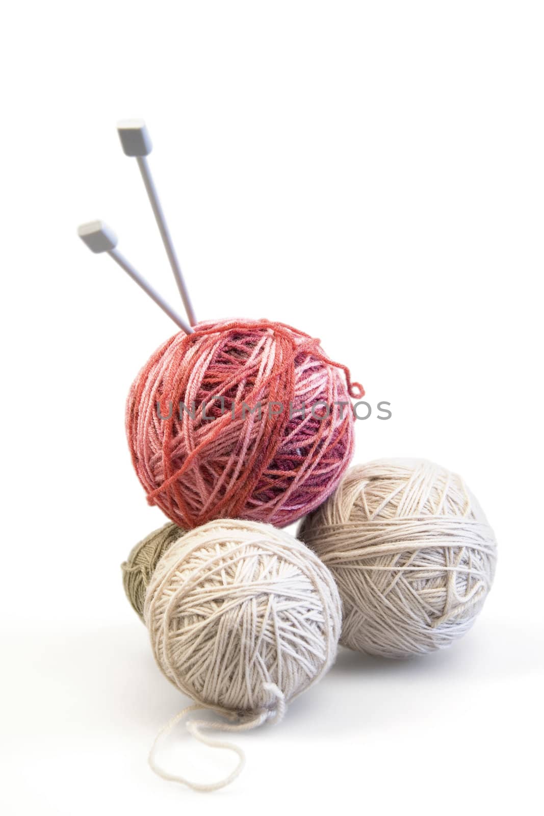 Spokes and color balls from wool on a white background