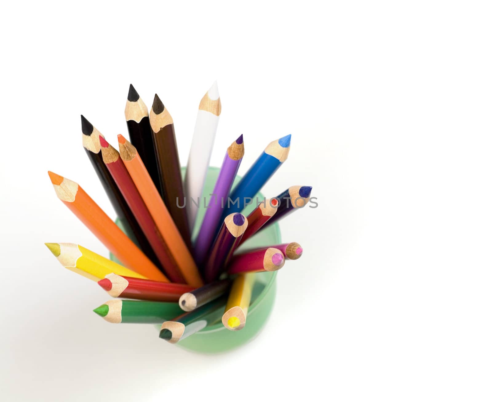 Color pencils in a glass on a white background