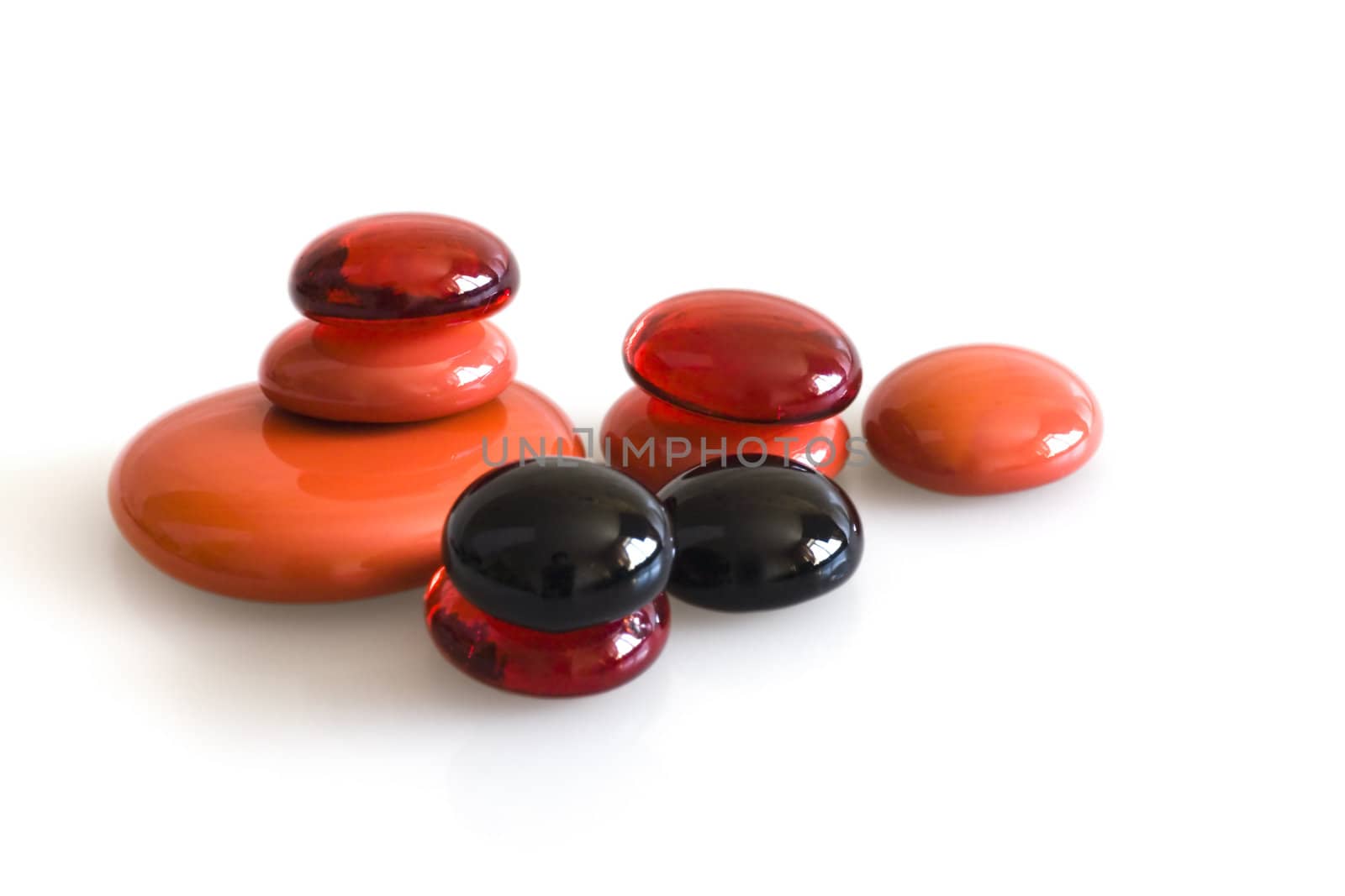 red and black polished stones on white background