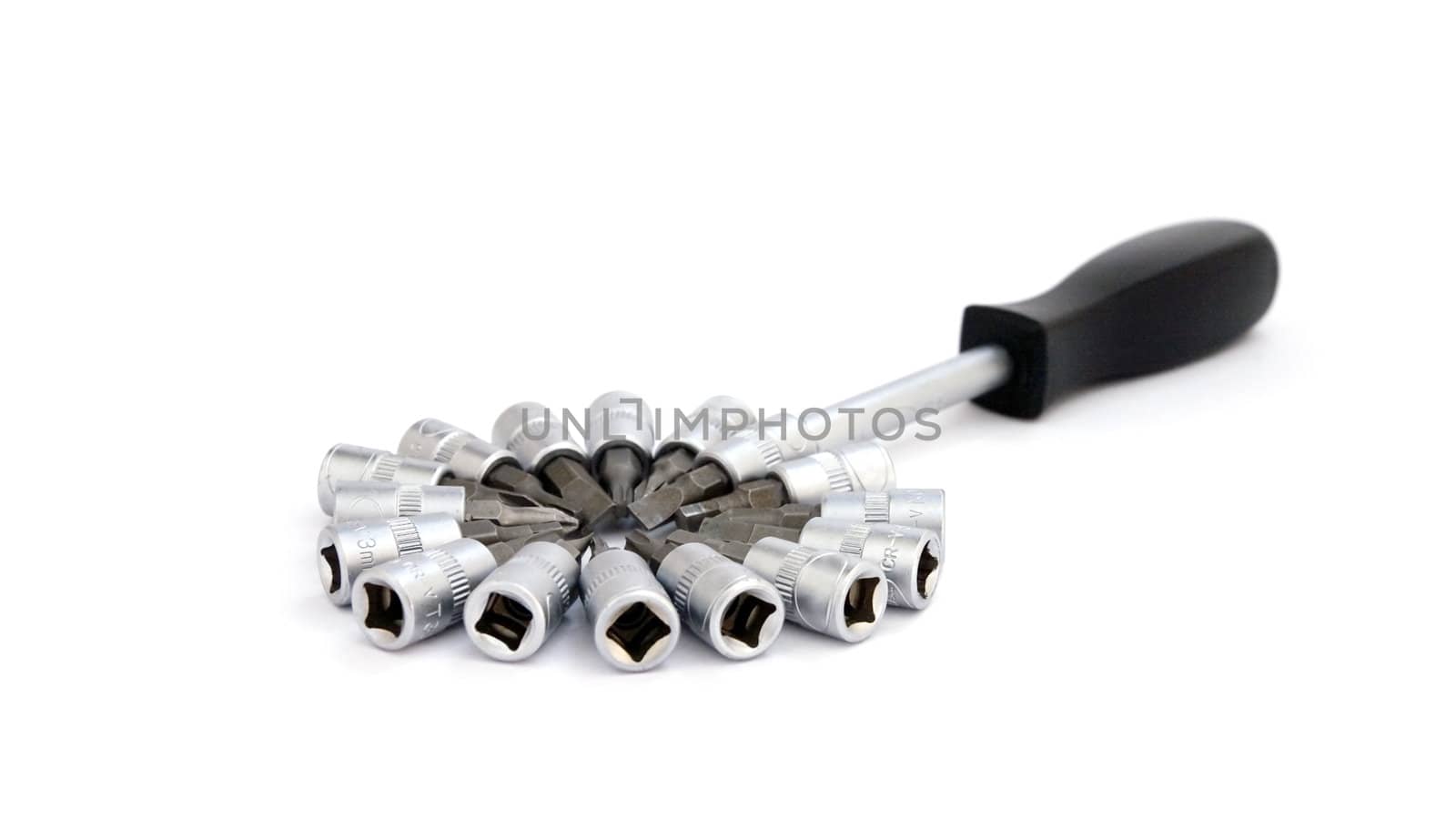 Screwdriver with various metal nozzles on a white background