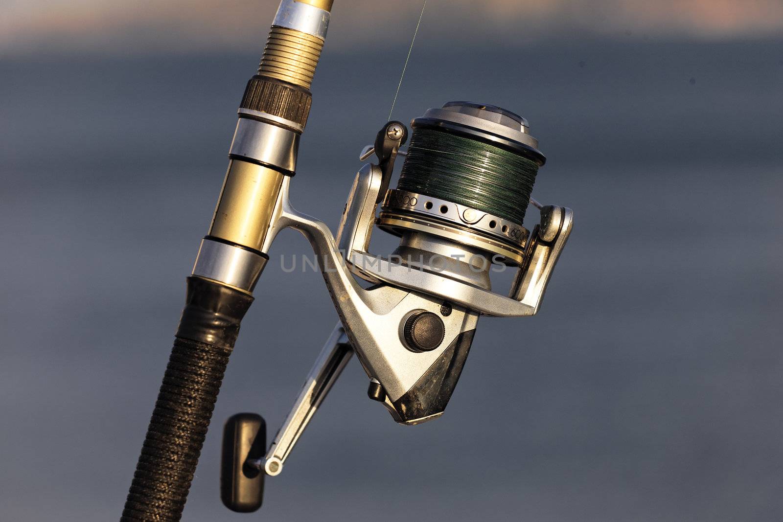 fishing reel on the beach with summer sunlight